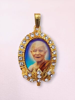 Double-sided Thai Buddhist amulet pendant with Ajahn Maha Bua on the front and Mahabodhi Temple on the back, framed in gold with crystal accents.