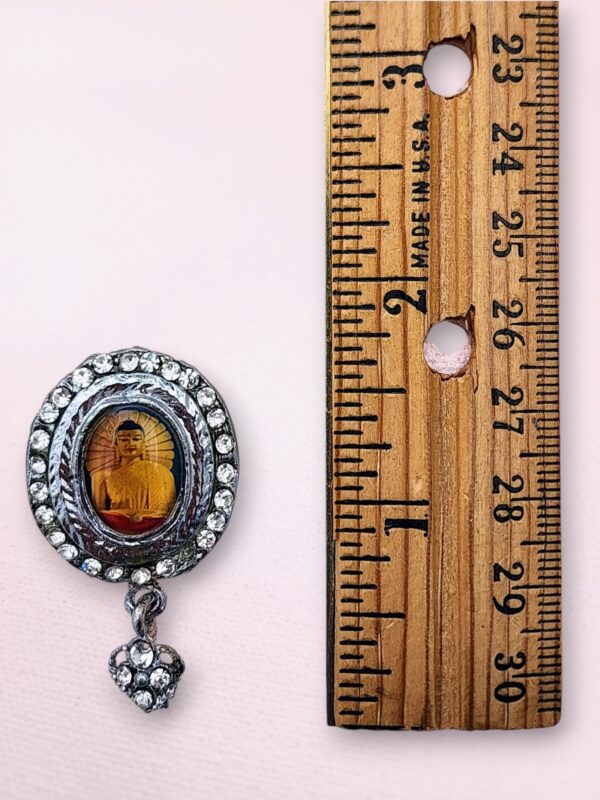 Silver-tone Buddha pin with rhinestones from Bodh Gaya featuring a colorful image and dangling heart charm.