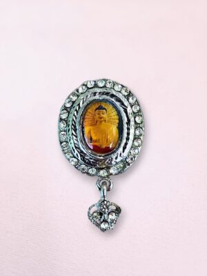 Silver-tone Buddha pin with rhinestones from Bodh Gaya featuring a colorful image and dangling heart charm.