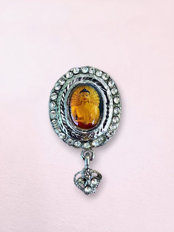 Silver-tone Buddha pin with rhinestones from Bodh Gaya featuring a colorful image and dangling heart charm.